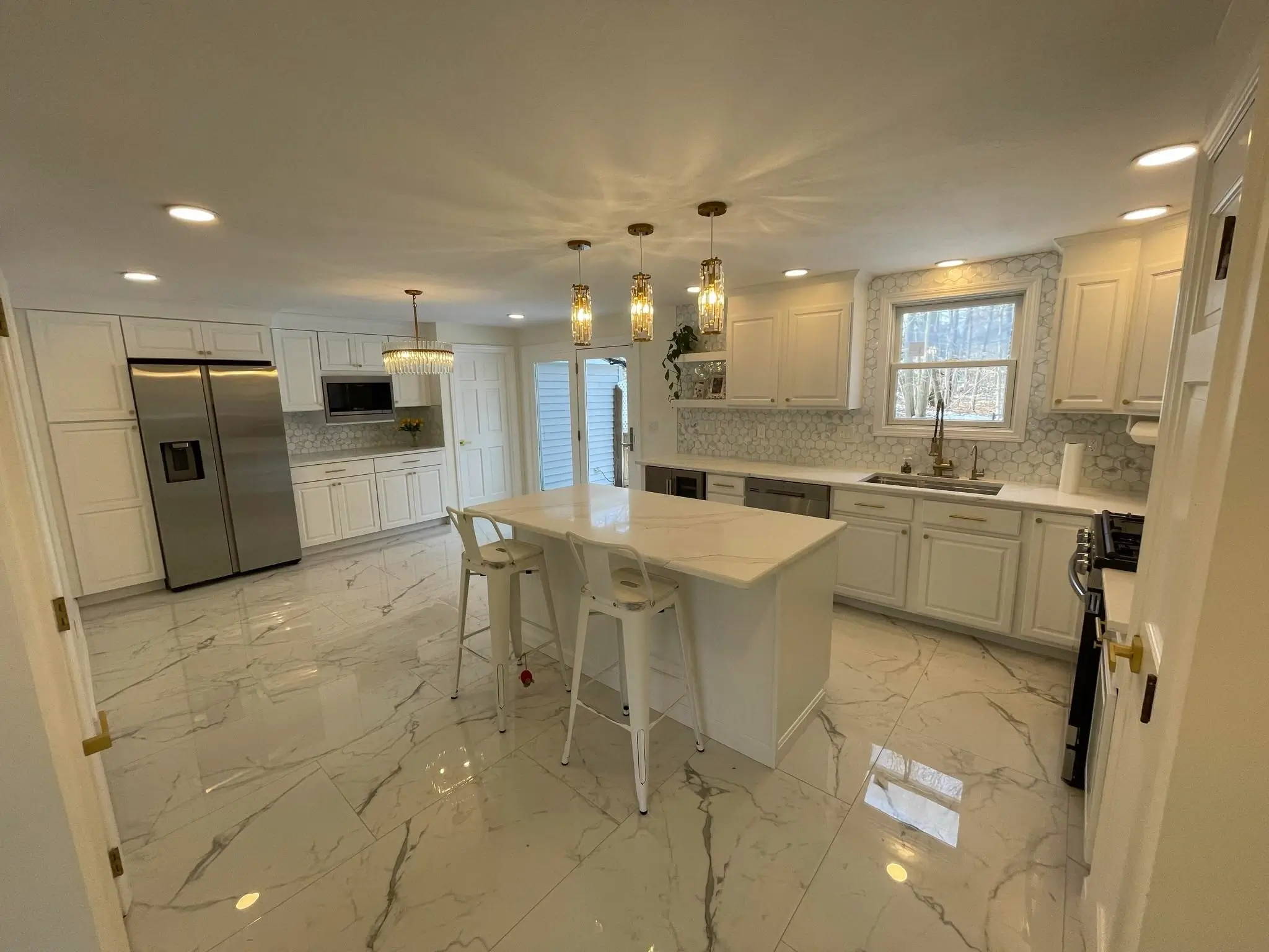 Kitchen remodel detailing white shaker cabinets and a subway tile backsplash.